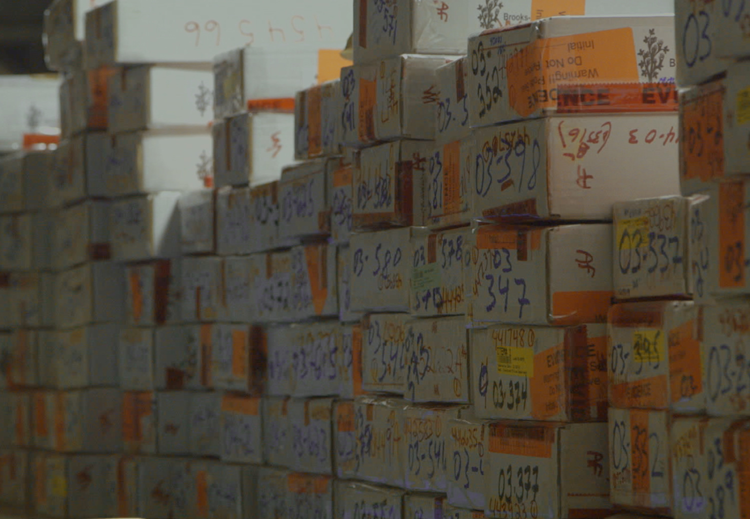 Image of room with piles of boxes of rape kits