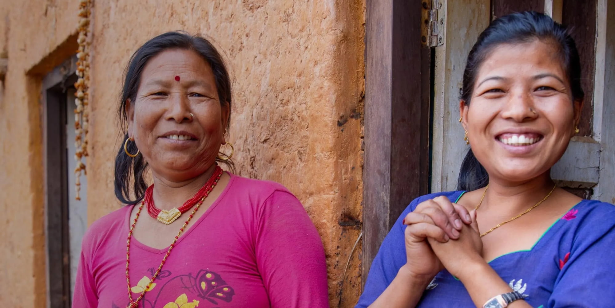 Two women standing by the door