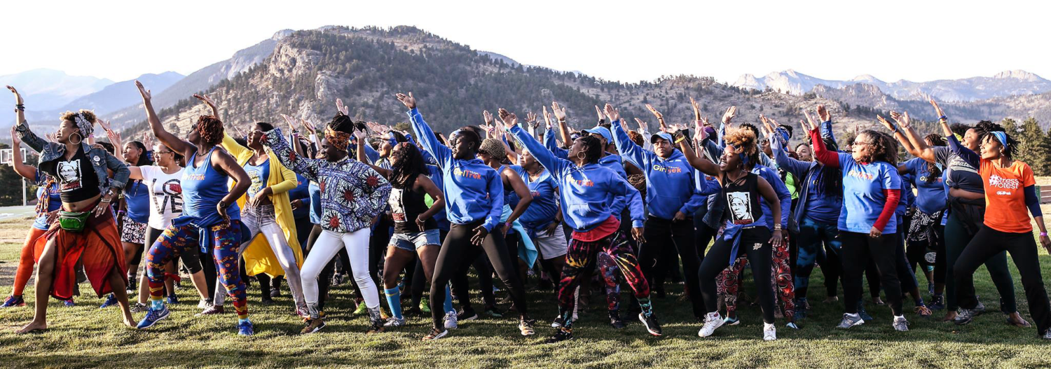 GirlTrekkers doing a synchronized dance outside at an out-of-town event