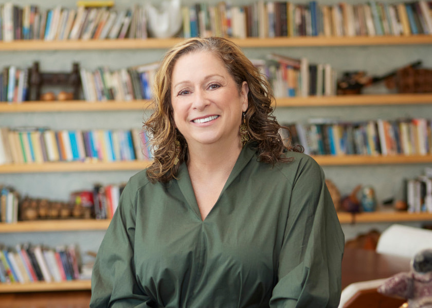 Abigail Disney in front of a shelf of books in the background