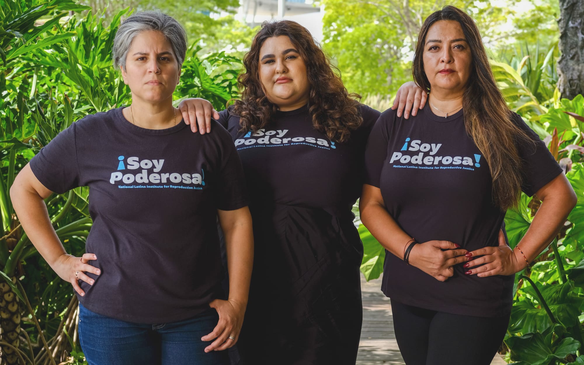 Three Latinas wearing a shirt that says 