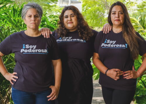 Three Latinas wearing a shirt that says 
