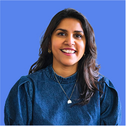 headshot of Aruna Mall smiling against a blue background