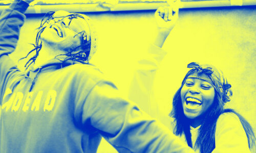 A joyous Black woman and man dancing with a duotone filter on top of the image making it blue and yellow
